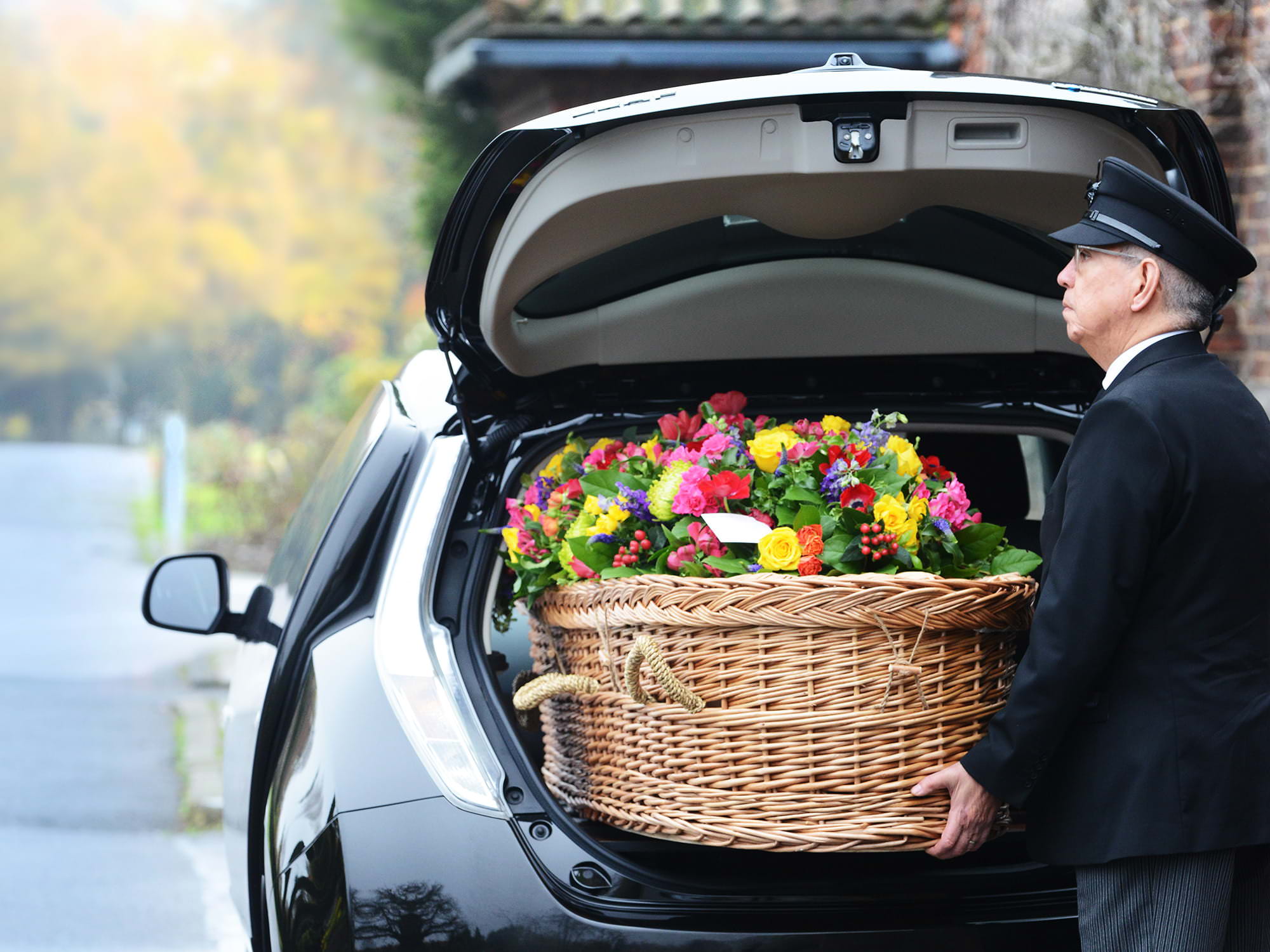 Electric Hearse at a service with casket being loaded